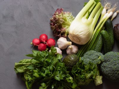 The concept of a healthy diet, products for a healthy balanced lifestyle. Green vegetables on a dark table with place for text